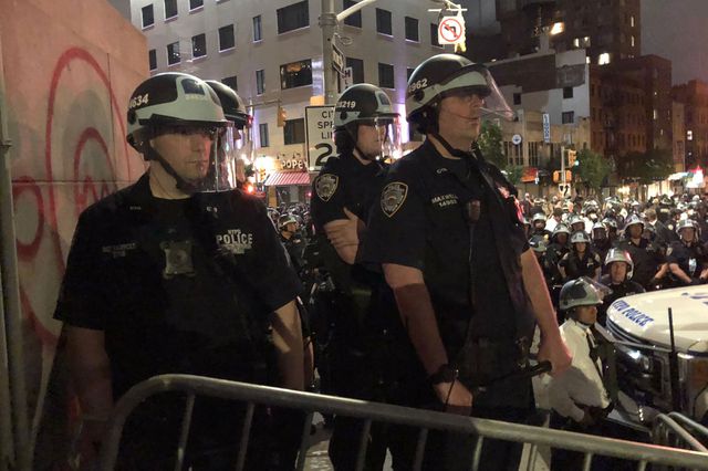NYPD officers watch a protest unfold in Brooklyn in early June. Their body cameras do not appear to be turned on.